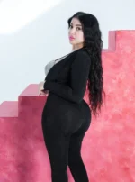 A jumpsuit with an open design and a shiny silver bustier - Image 4